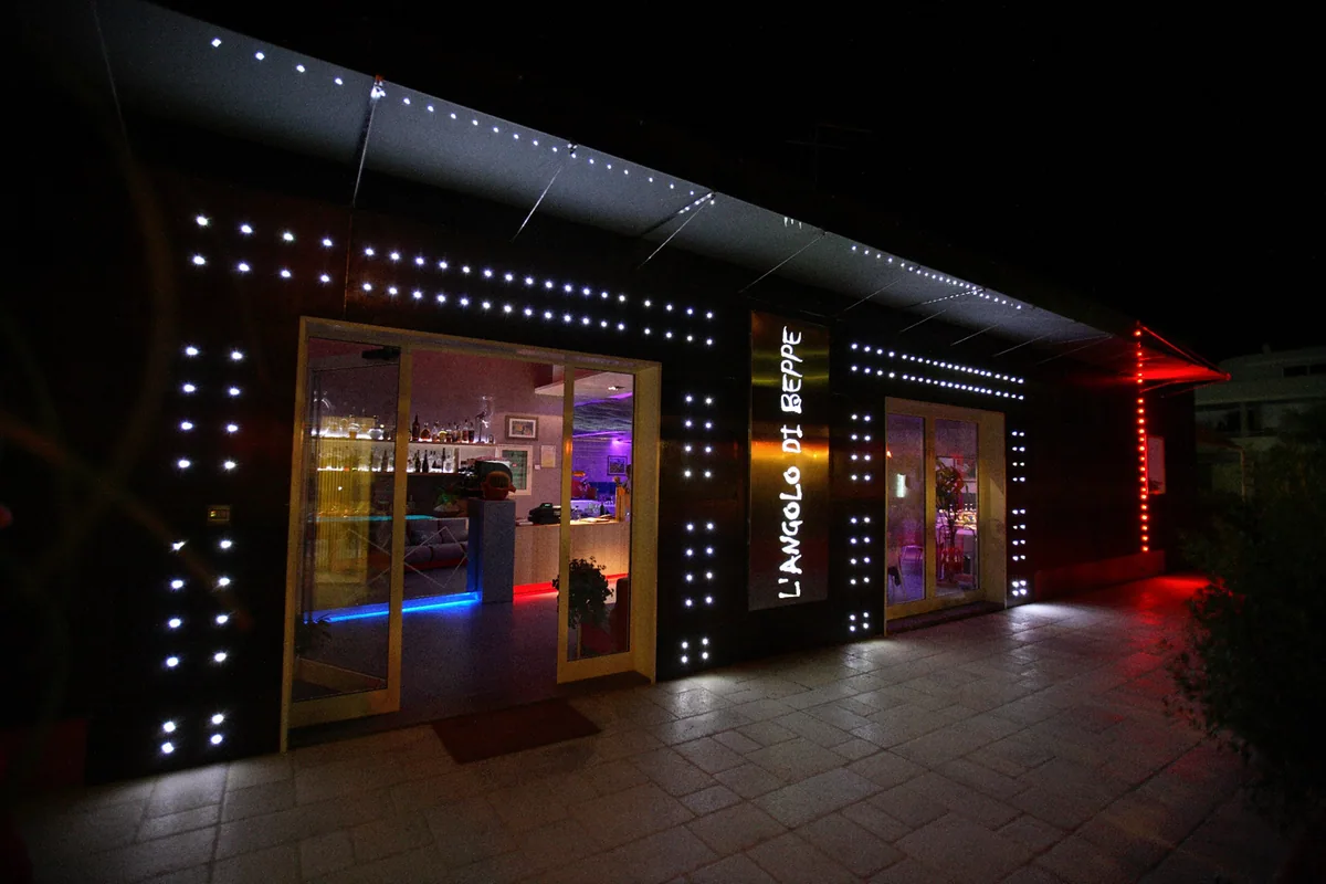 The illuminated entrance of Hotel Restaurant L’Angolo di Beppe in Torre Lapillo